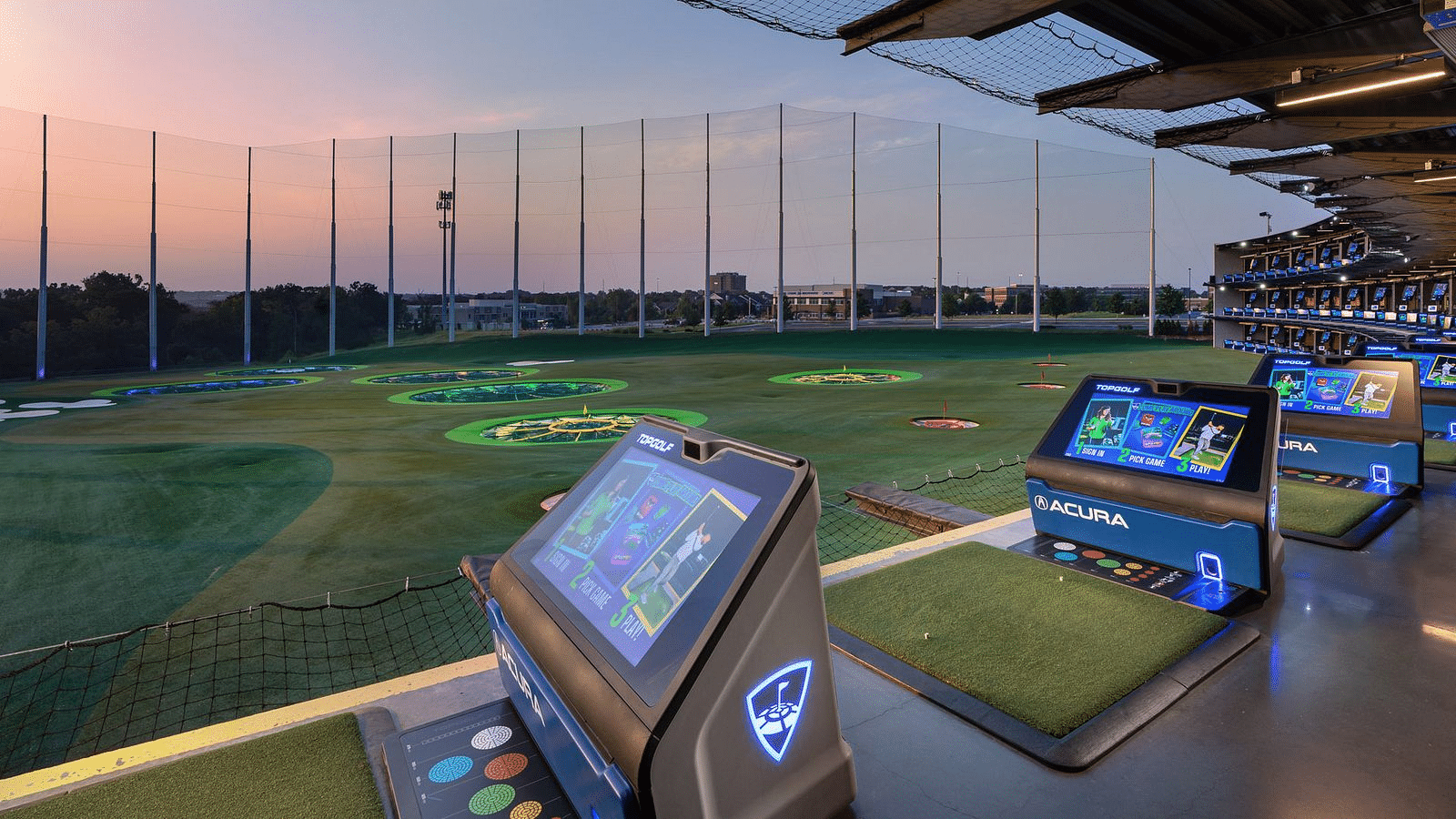 Topgolf bays at sunset with event branding